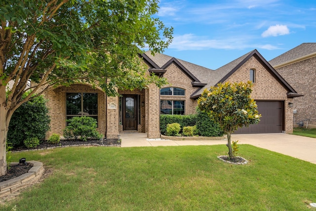 305 Dorset Ct, Roanoke, TX 76262 - view of front of home with brick siding, driveway, a front lawn, and a garage
