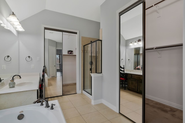 bathroom with tile patterned flooring, a shower stall, lofted ceiling, a bath, and vanity