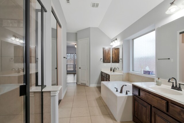 bathroom featuring tile patterned floors, a garden tub, visible vents, and a sink