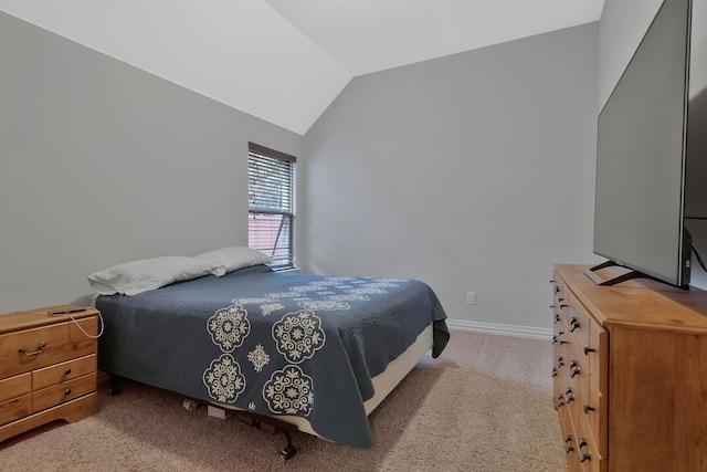 bedroom with vaulted ceiling, carpet, and baseboards