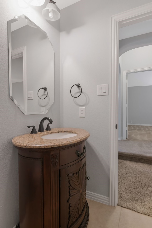 bathroom with vanity, tile patterned floors, and baseboards