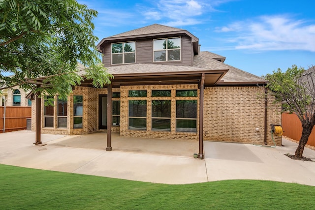 305 Dorset Ct, Roanoke, TX 76262 - back of property with a patio, brick siding, and a shingled roof