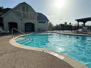 pool featuring fence and a patio area