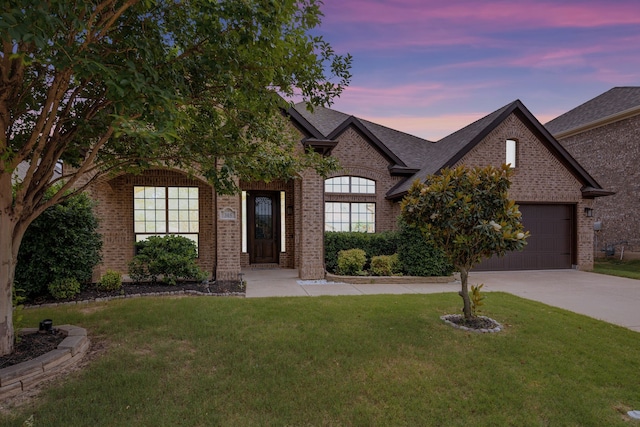 305 Dorset Ct, Roanoke, TX 76262 - french country inspired facade featuring brick siding, concrete driveway, a yard, an attached garage, and roof with shingles