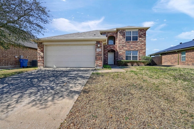 view of front of property with brick siding, a front lawn, central air condition unit, driveway, and an attached garage