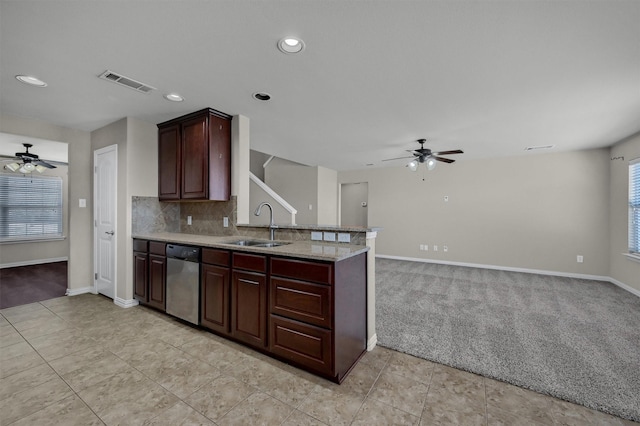 kitchen with visible vents, light carpet, a sink, stainless steel dishwasher, and a peninsula