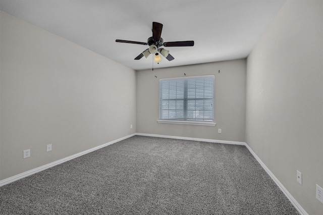 empty room with ceiling fan, baseboards, and carpet