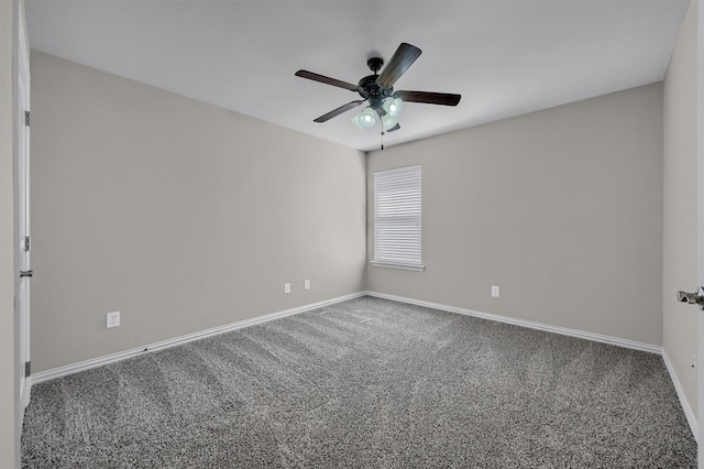 carpeted empty room featuring baseboards and ceiling fan