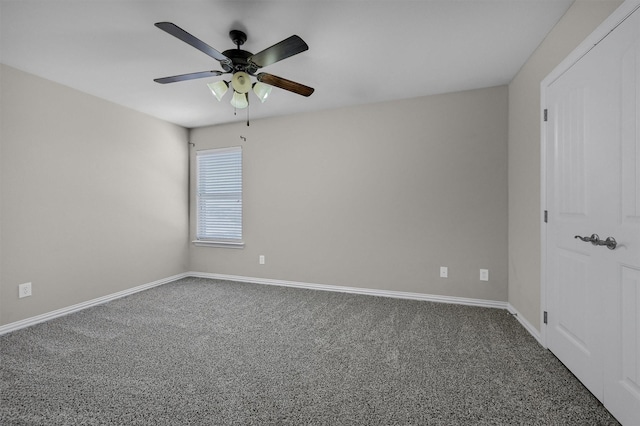 carpeted spare room with baseboards and ceiling fan