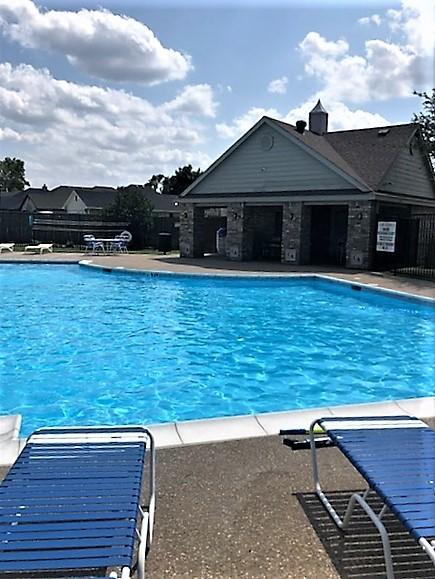 community pool featuring a patio area and fence