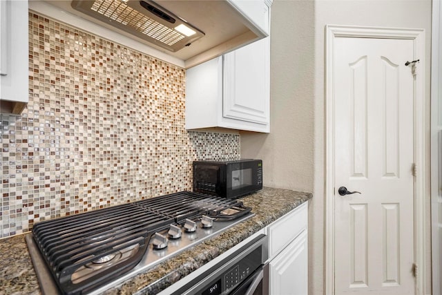 kitchen with tasteful backsplash, stainless steel gas stovetop, extractor fan, a textured wall, and white cabinets