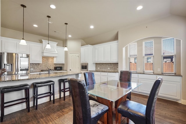 dining room featuring recessed lighting, visible vents, lofted ceiling, and dark wood-style floors