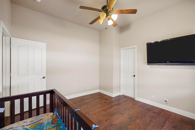 unfurnished bedroom with ceiling fan, baseboards, and wood finished floors