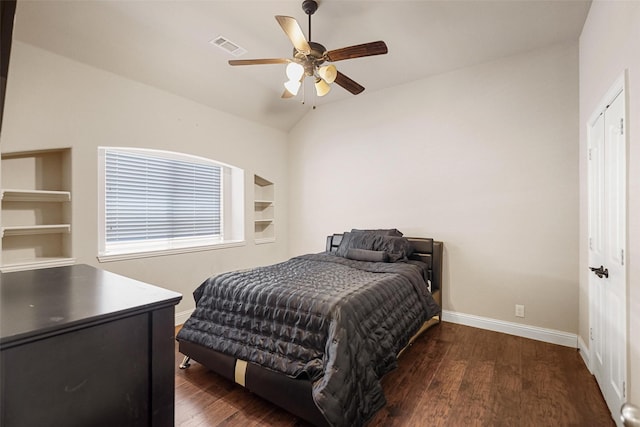 bedroom with visible vents, wood finished floors, baseboards, ceiling fan, and vaulted ceiling