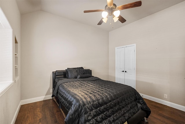 bedroom with a ceiling fan, wood finished floors, baseboards, vaulted ceiling, and a closet