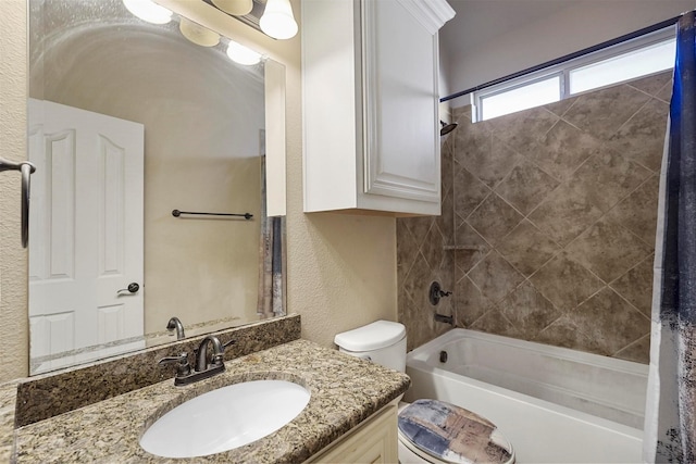 bathroom featuring vanity, toilet, shower / bathtub combination with curtain, and a textured wall