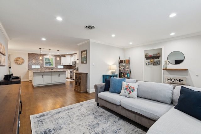 living room with visible vents, recessed lighting, crown molding, and dark wood-type flooring