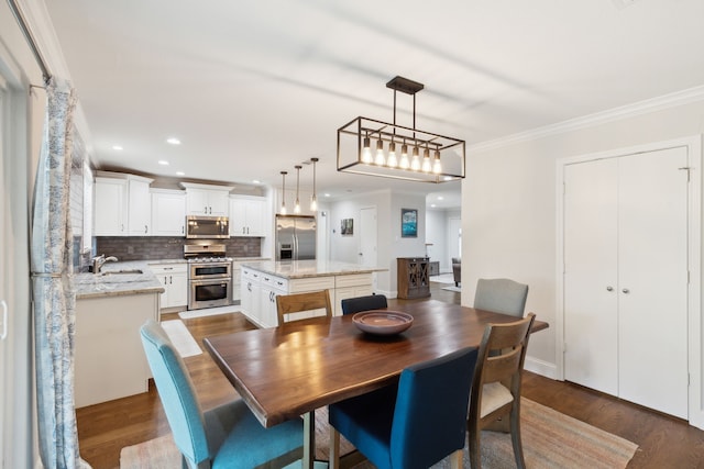 dining area with dark wood finished floors, recessed lighting, and ornamental molding