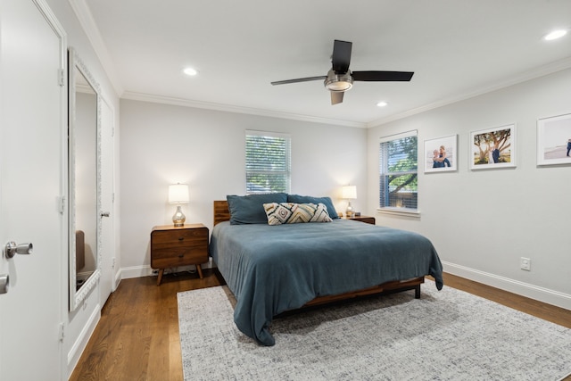 bedroom with baseboards, multiple windows, and wood finished floors