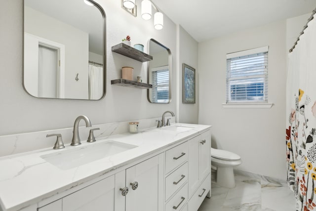 bathroom with a sink, marble finish floor, and a wealth of natural light