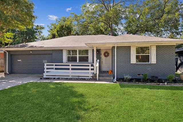 ranch-style home featuring a garage, driveway, brick siding, and a front yard