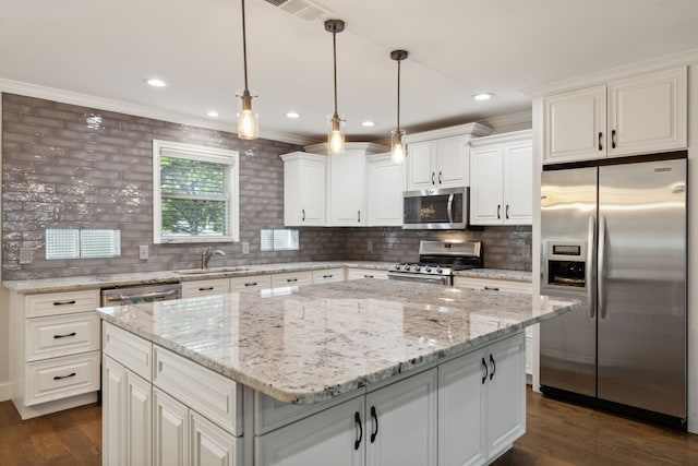 kitchen with dark wood finished floors, ornamental molding, stainless steel appliances, and a sink