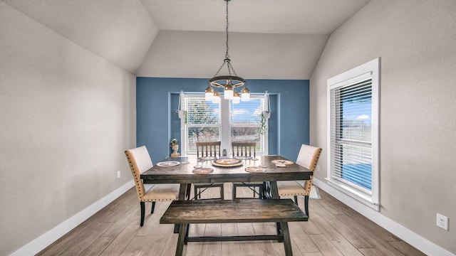 dining room with plenty of natural light, light wood-style floors, and vaulted ceiling