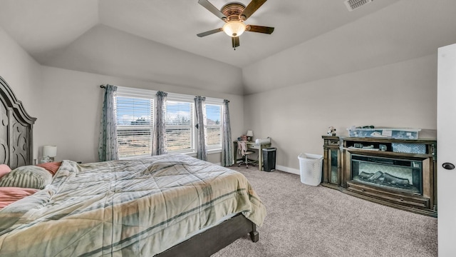 carpeted bedroom featuring visible vents, ceiling fan, baseboards, lofted ceiling, and a glass covered fireplace