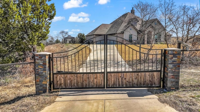 view of gate with fence