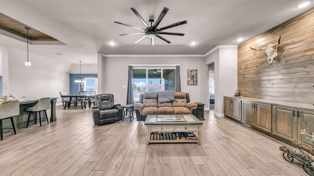 living area featuring ceiling fan, ornamental molding, recessed lighting, and light wood finished floors