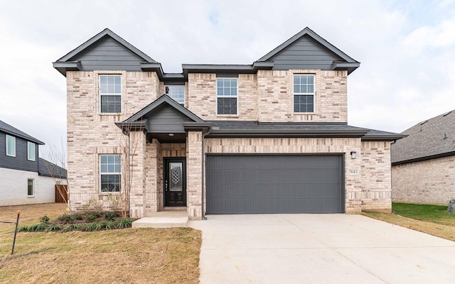 traditional home featuring a garage, a front yard, brick siding, and driveway