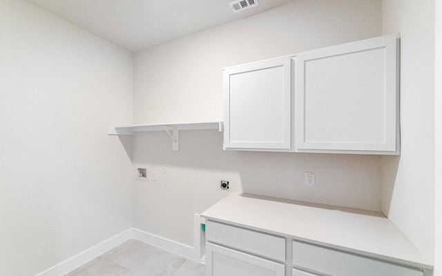 clothes washing area with electric dryer hookup, visible vents, washer hookup, cabinet space, and baseboards