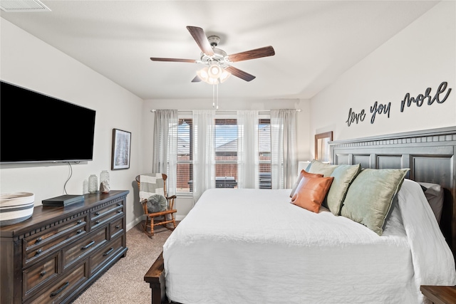 carpeted bedroom featuring baseboards, visible vents, and ceiling fan