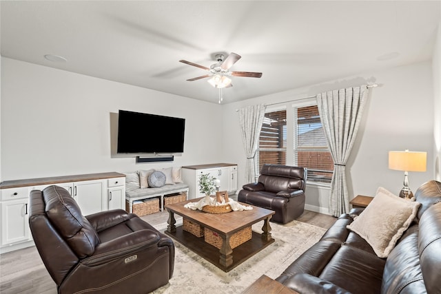 living area featuring a ceiling fan and light wood-type flooring