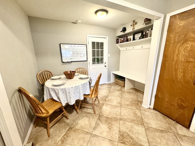 dining room featuring baseboards and light tile patterned flooring