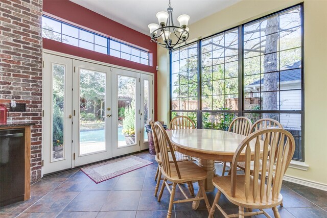 dining space featuring a notable chandelier, french doors, baseboards, and a wealth of natural light