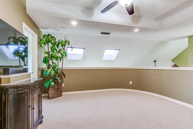 unfurnished room featuring a ceiling fan, carpet flooring, baseboards, and visible vents