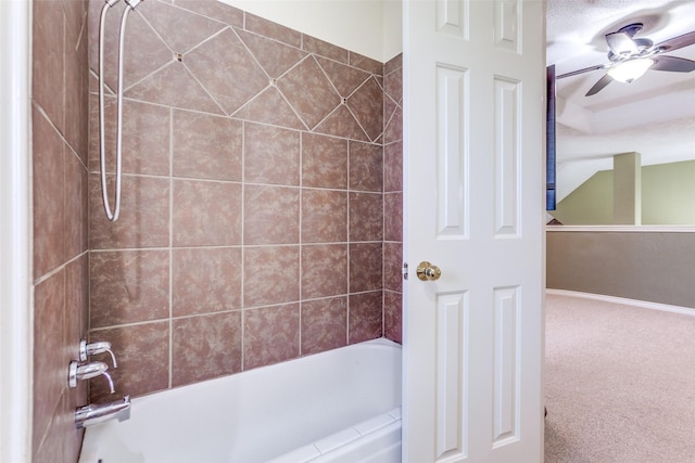 bathroom featuring  shower combination and ceiling fan