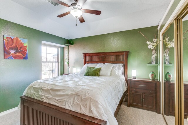 bedroom with visible vents, baseboards, carpet flooring, a textured wall, and a ceiling fan