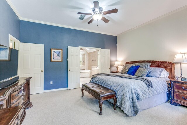 carpeted bedroom with visible vents, ceiling fan, baseboards, ornamental molding, and ensuite bath