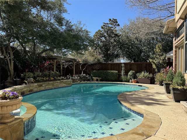 view of pool with a pergola, a fenced backyard, a fenced in pool, and a patio area