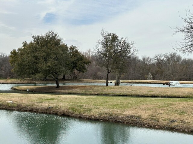 view of home's community featuring a lawn and a water view