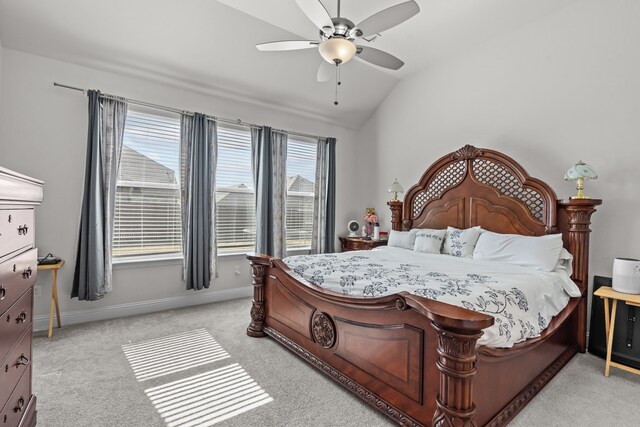 bedroom with baseboards, light carpet, a ceiling fan, and vaulted ceiling