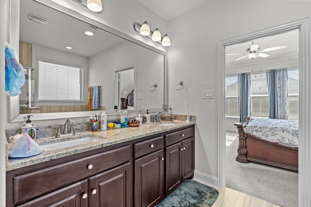 ensuite bathroom featuring a sink, visible vents, ensuite bath, and double vanity