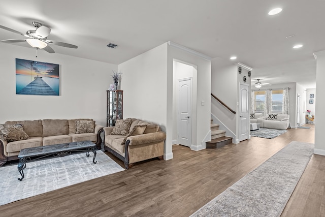 living room featuring visible vents, ceiling fan, stairs, recessed lighting, and wood finished floors