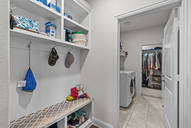 laundry room with laundry area, light tile patterned floors, visible vents, and washer and clothes dryer