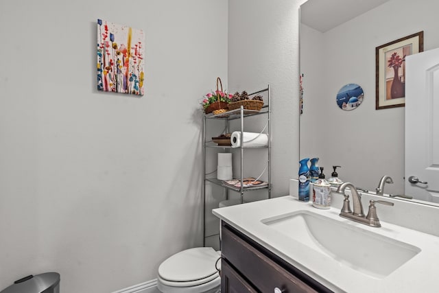 bathroom featuring toilet and vanity