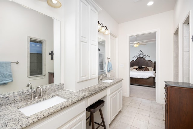 bathroom with tile patterned flooring, double vanity, ensuite bathroom, and a sink