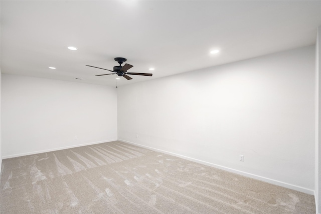 spare room featuring recessed lighting, baseboards, light carpet, and ceiling fan