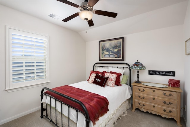 carpeted bedroom featuring visible vents, baseboards, ceiling fan, and vaulted ceiling